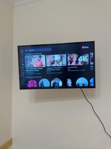a flat screen tv hanging on a wall at Davit's Apartments 21 in Tbilisi City