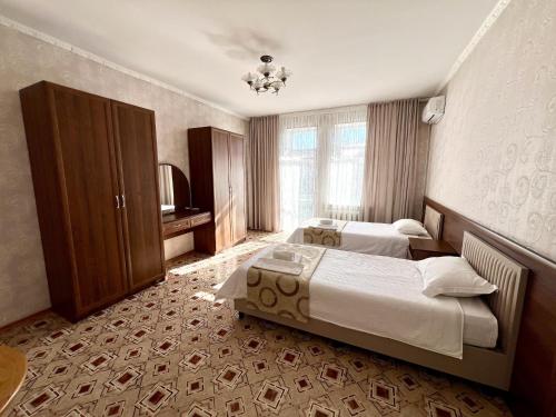 a hotel room with two beds and a television at Гостиница Караганда in Karagandy