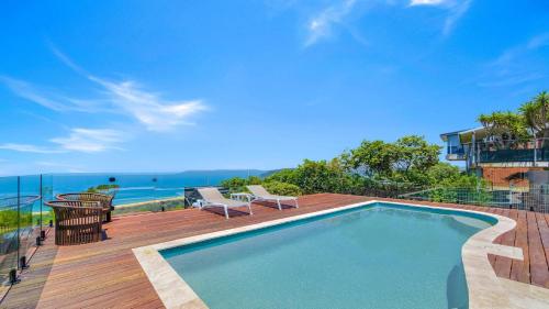 a swimming pool on a deck with a view of the ocean at 'Ocean Pearl' by HolidayCo in Hardys Bay