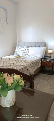 a bedroom with a bed and a table with a plant at Thyme residences condominium, Unit 208 in Cebu