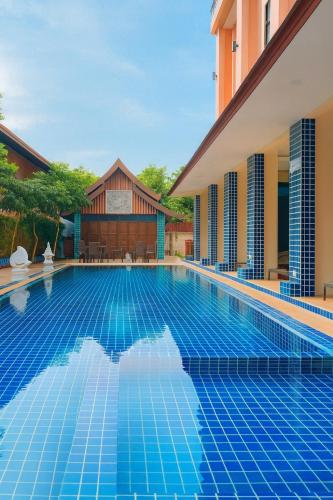 a swimming pool in front of a villa at Mido Selected Resort Pool Hotel in Pattaya