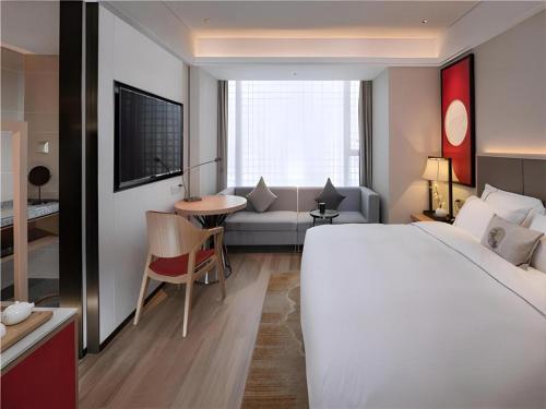 Postel nebo postele na pokoji v ubytování Echeng Hotel Nanning the Mixc Convention