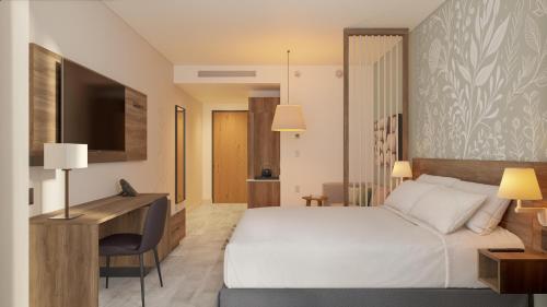 a hotel room with a bed and a desk at Hyatt Place Cancun Airport in Cancún