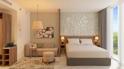 a bedroom with a bed and a couch and a chair at Hyatt Place Cancun Airport in Cancún