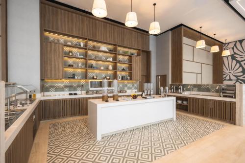 a large kitchen with a white island in the middle at Hyatt Place Cancun Airport in Cancún