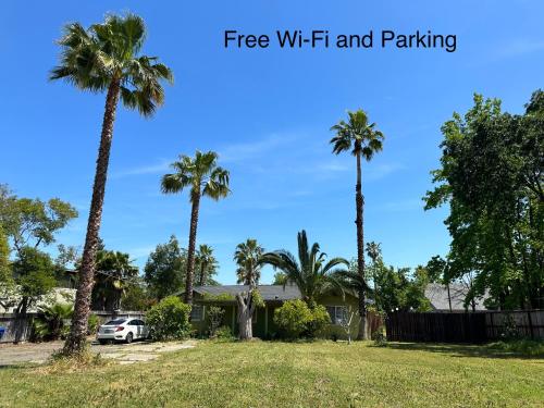 a house with palm trees in a yard at Kitchen Suite A in Sacramento