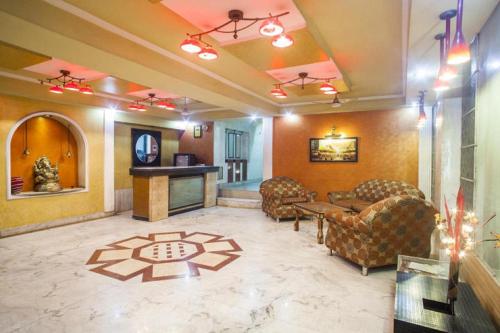 a lobby with couches and a table and a fireplace at Hotel Airlines in Amritsar