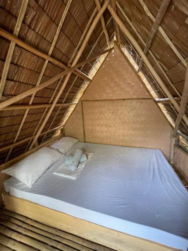 En eller flere senge i et værelse på Akoya Beach Park and Cottages - El Nido