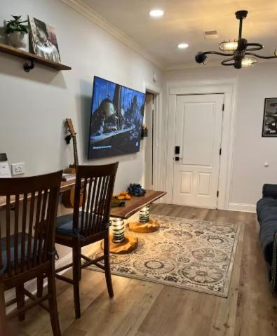 a living room with a table and chairs and a couch at Cozy Downtown Cottage - Parking, Pet Friendly! in Wilmington