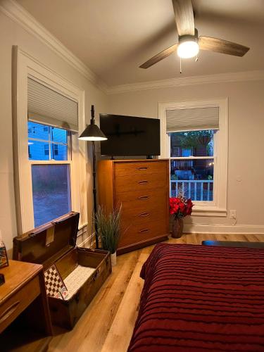 a bedroom with a bed and a flat screen tv at Cozy Downtown Cottage - Parking, Pet Friendly! in Wilmington