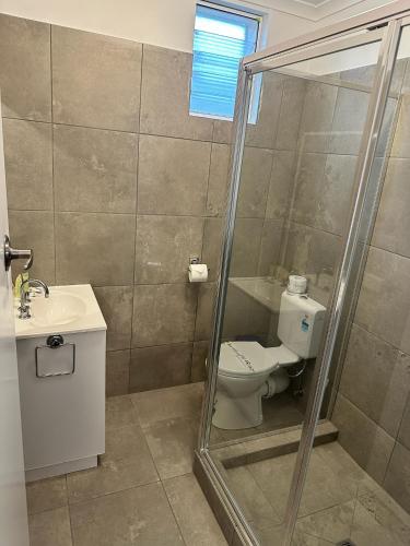 a bathroom with a toilet and a sink at Bamboo Motor Inn in Lakes Entrance