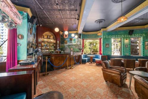 a bar with green walls and brown chairs at Hotel Harry, an Ascend Collection Hotel in Sydney