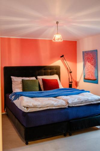 a bedroom with a bed with colorful walls and a lamp at HeartArt in Bad Münstereifel