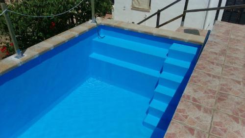 a large blue swimming pool with blue water at Casa Julia Llucmajor in Llucmajor