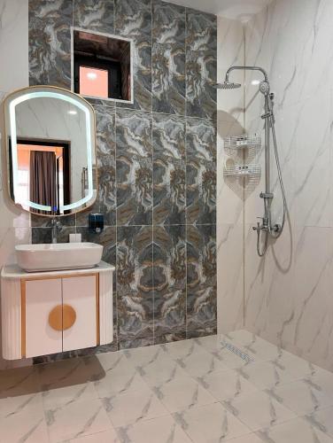 a bathroom with a sink and a mirror at Hilltop Hotel Gusar in Qusar