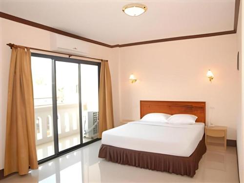 a bedroom with a bed and a large window at Chaleunehoung Hotel in Ban Houadông