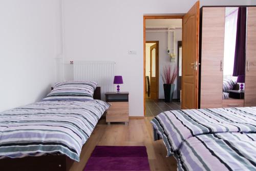 Postel nebo postele na pokoji v ubytování Levendula Vendégház