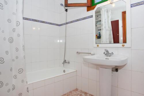 a white bathroom with a sink and a shower at Casa Julia Llucmajor in Llucmajor