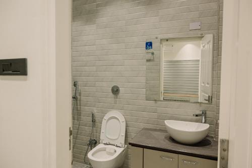 a bathroom with a toilet and a sink at Vanilla Country in Dibrugarh