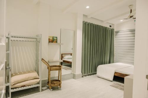 a bedroom with two bunk beds and a mirror at Vanilla Country in Dibrugarh