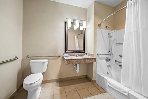 a bathroom with a toilet and a shower and a sink at Quality Inn Dubuque on Hwy 20 in Dubuque