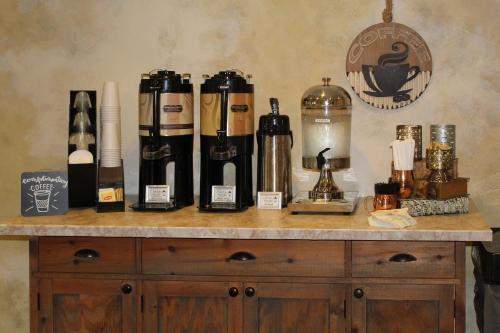 a counter with a bunch of wine bottles on it at The Century House, an Ascend Collection Hotel in Latham