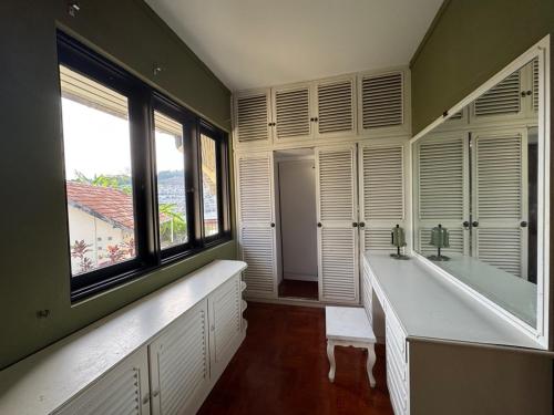 a bathroom with a tub and a sink and windows at VELAMUNDi INN Batu Ferringhi in Batu Ferringhi