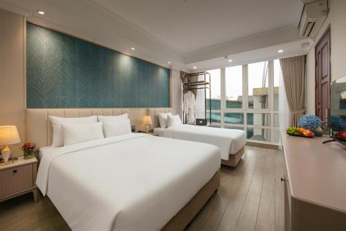 En eller flere senge i et værelse på Dong Xuan Boutique Hotel