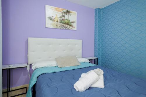 En eller flere senge i et værelse på Duque Center Premium Suites