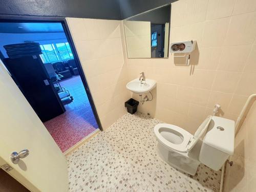 a bathroom with a toilet and a sink at Destiny House Hostel in Hat Yai