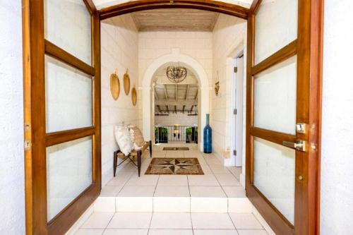 a hallway with a door open to a living room at Kyalami - by ZenBreak in Saint James