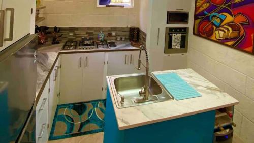 a kitchen with a sink and a counter at Villa De Lasannta - by ZenBreak in Christ Church