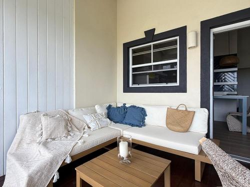 a living room with a white couch and a table at Lantana Sea La Vie - by ZenBreak in Saint James