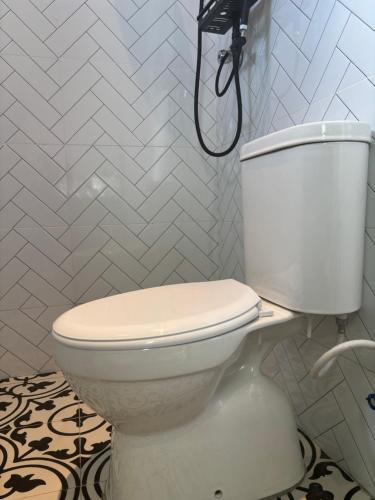 a bathroom with a white toilet in a room at De Rooma KLIA Mini Hotel in Banting