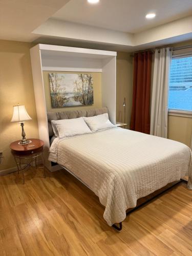 a bedroom with a bed and a table and a window at Amazon Park Studio in Eugene