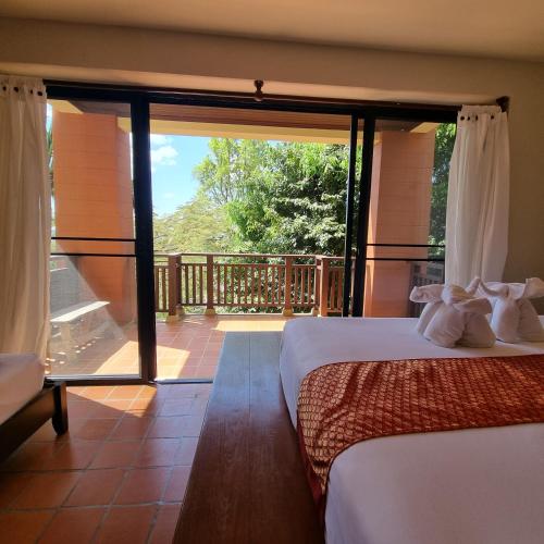 a bedroom with a view of a balcony with two beds at The Great Escape Pool Seaview Villa in Ko Lanta