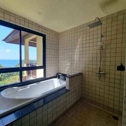 a bath tub in a bathroom with a window at The Great Escape Pool Seaview Villa in Ko Lanta
