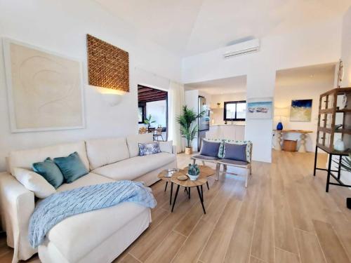 a living room with a couch and a table at Costa Christina con piscina climatiza in Yaiza