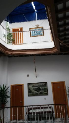 a room with a balcony on the ceiling of a building at Hostal Centro Sol in Cádiz