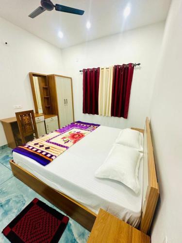 a bedroom with a large bed in a room at Zonooro Homestay Vythiri in Vythiri