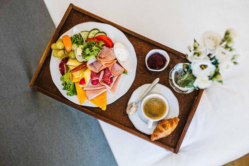ein Tablett mit einem Teller Essen auf einem Tisch in der Unterkunft Hotel Windsor w Jachrance in Jachranka