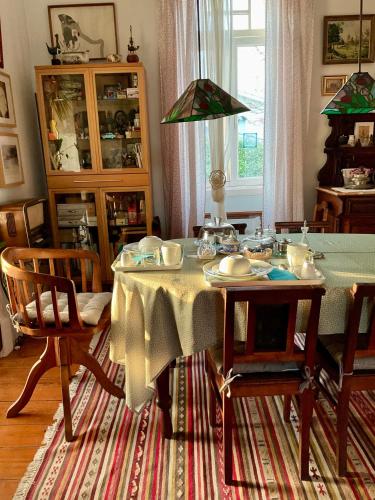 a dining room with a table with dishes on it at Casa do Paço Aveiro Studio&Rooms in Aveiro