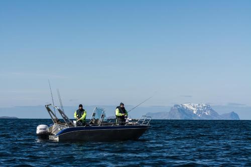 three people on a boat in the water at XLyngen in Nord-Lenangen