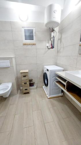 a bathroom with a washing machine and a sink at Amana in Bandraboua