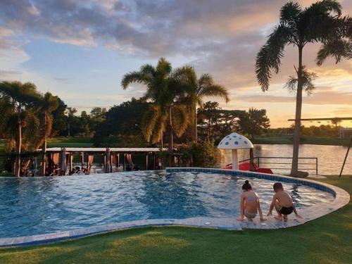two people standing in a swimming pool at a resort at I View Park Resort in Ban Non Sung