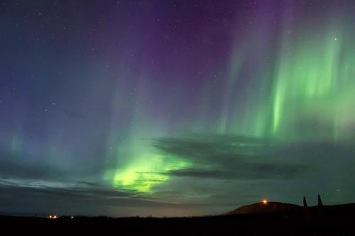 an image of the northern lights in the sky at Saltvík Farm Guesthouse in Húsavík