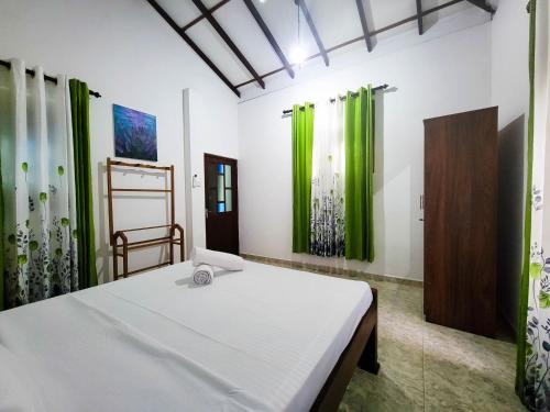 Ένα ή περισσότερα κρεβάτια σε δωμάτιο στο Oni Omi Vlla Hikkaduwa