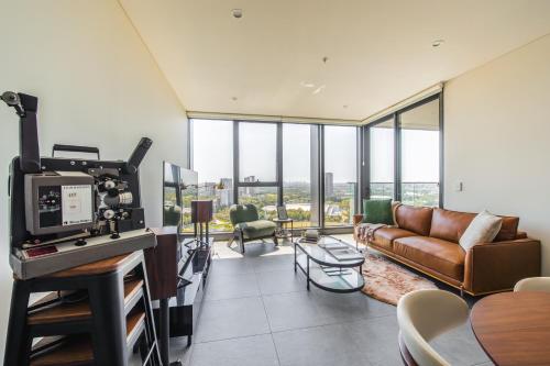 a living room with a couch and a table at SkyHaus - City & Fireworks View 2 Bed Apartment in Sydney