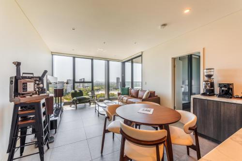 a living room with a table and chairs at SkyHaus - City & Fireworks View 2 Bed Apartment in Sydney