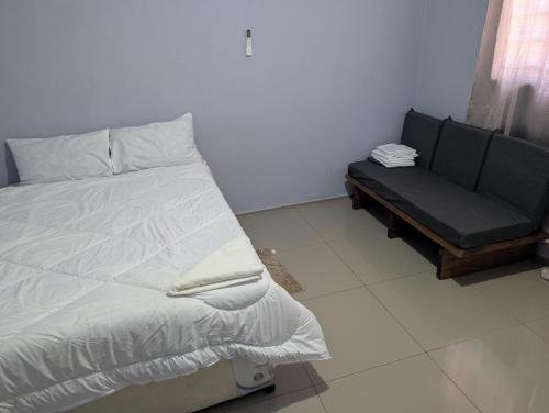 a bed and a couch in a room at Gravity Apartments & Lodges in Mazabuka